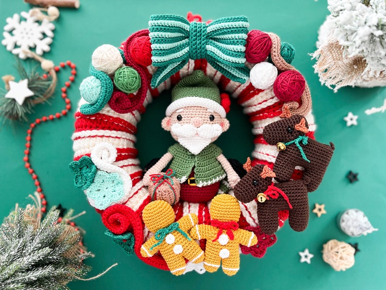 May include: A crocheted Christmas wreath with a green and white bow, a Santa Claus figure, gingerbread people, and reindeer ornaments.