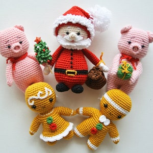 May include: A collection of crocheted Christmas toys including a Santa Claus, two gingerbread people, and two pink pigs. The Santa Claus is holding a small Christmas tree and a bag of gifts.
