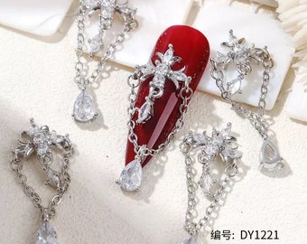 Cross chain nail dangle