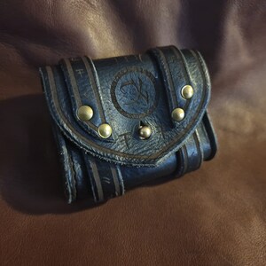 Leather pouch, wallet, or cardholder with arcane design.