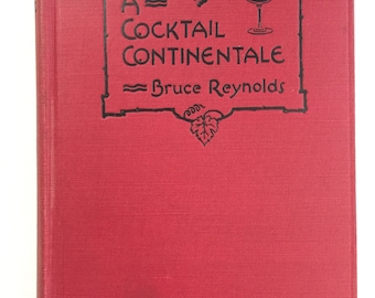 May include: A red hardcover book with a black title on the front cover. The title is "A Cocktail Continentale" by Bruce Reynolds. The book cover features a decorative frame with a grapevine and a glass of wine.
