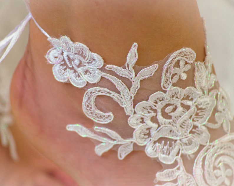 May include: White lace trim with a floral design. The lace is delicate and intricate, with a soft, feminine feel.