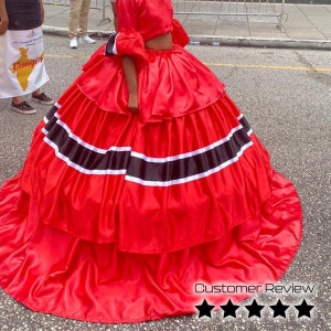 May include: A red satin skirt with black and white stripes. The skirt is layered and has a full, flowing shape.