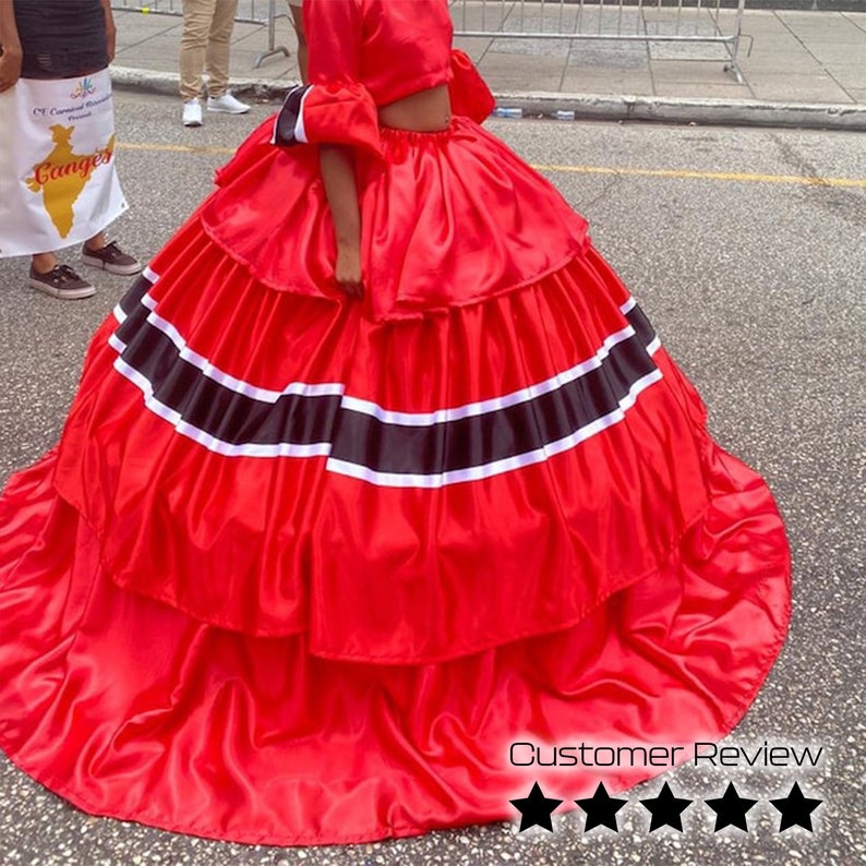 May include: A red satin skirt with black and white stripes. The skirt is layered and has a full, flowing shape.