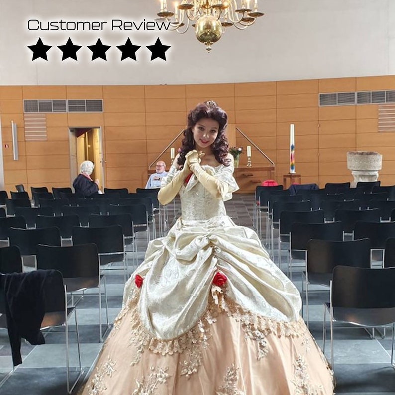 May include: A woman dressed as Belle from the Disney movie Beauty and the Beast. She is wearing a gold and white ball gown with a lace trim and red roses. She is standing in a church with rows of black chairs.