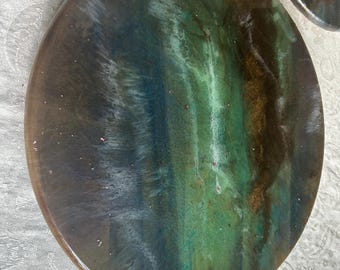 Beautiful 18 inch acacia wood lazy susan with epoxy resin design. Colors of blue green, gold and a bronze. Smooth turning motion.