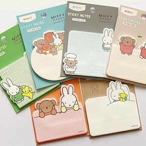 May include: A selection of Miffy & Friends sticky notes in various colours. Each pad features a different design with cartoon characters, including a bunny, bear, and dog. The pads have grid or blank pages.