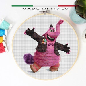 May include: Cross stitch pattern of a pink elephant character with a black jacket and a bow tie. The character is smiling and has its arms outstretched. The pattern is on a white background.