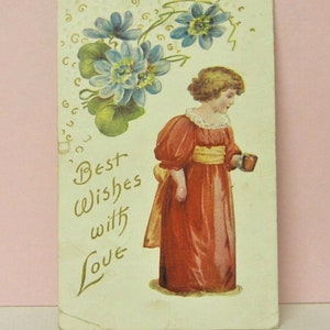May include: Vintage postcard featuring a girl in a red dress holding a cup, with blue flowers and green leaves in the background. The text "Best Wishes with Love" is written in gold script.