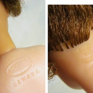 May include: Close-up of a doll's head with brown hair. The doll has a  "Mattel Canada" stamp on the back of its neck.