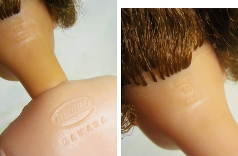 May include: Close-up of a doll's head with brown hair. The doll has a  "Mattel Canada" stamp on the back of its neck.