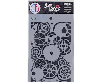 May include: A stencil featuring a pattern of overlapping gears in black and gray. The stencil is packaged in a clear plastic bag with the text "Bad Girls" and "Stencil for Papercrafting, Scrapbooking, Mixed Media & More" printed on it.