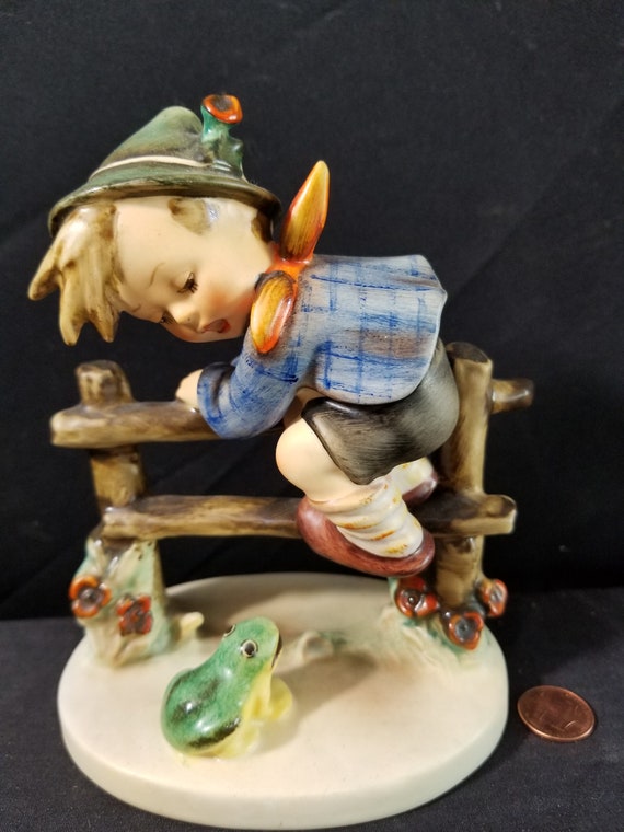 hummel boy on fence with frog
