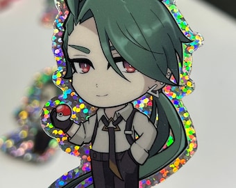 May include: A holographic sticker featuring a cartoon character with green hair, wearing a white shirt, black pants, and a black tie. The character is holding a red and white Pokeball.