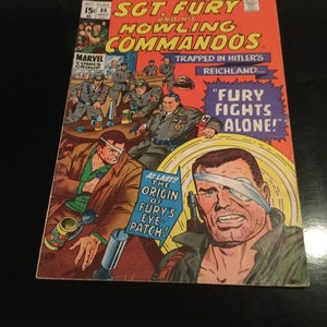 May include: A vintage comic book cover for "Sgt. Fury and His Howling Commandos." The cover features a dramatic illustration of a man with an eye patch, and the text "FURY FIGHTS ALONE!" The comic is from Marvel Comics Group.