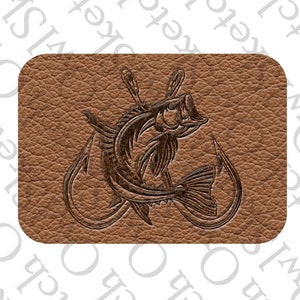 May include: A brown leather patch with a detailed engraving of a fish on two hooks. The fish is facing right and has a detailed design.
