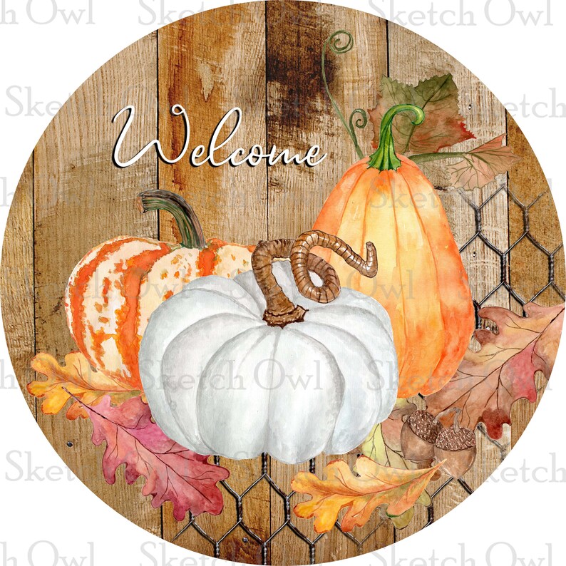 May include: A round wooden sign with a rustic woodgrain background and a wire mesh overlay. The sign features the word "Welcome" in a handwritten font and three pumpkins: one white, one orange, and one with orange and white stripes. The pumpkins are surrounded by autumn leaves in shades of red, orange, and yellow.