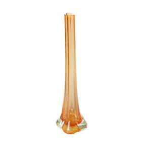 May include: A tall, slender orange glass vase with a flared base and a narrow neck. The vase has a ribbed texture and a clear, light green base. The vase is approximately 12 inches tall.