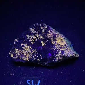 Fluorescent Wollastonite, and Franklinite. Yellow shortwave SW fluorescence. From Sterling Hill Mine, NJ.