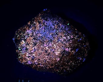 Fluorescent Birdseye Sphalerite and pyrite on zinc ore. Longwave fluorescent. From Balmat, NY - ET130