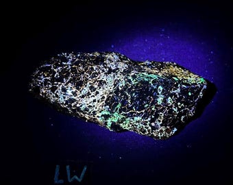 Fluorescent Sphalerite and pyrite  on zinc ore. Longwave fluorescent. From Balmat, NY - ET130