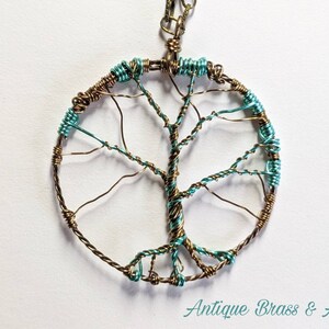 May include: A wire wrapped tree of life pendant necklace with antique brass and aqua colored wire.