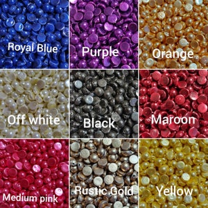 May include: Assortment of round, flat-backed, plastic embellishments in various colors, including royal blue, purple, orange, off-white, black, maroon, medium pink, rustic gold, and yellow.