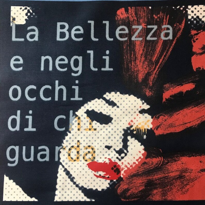 May include: A black and white image of a woman's face with red and orange paint strokes. The text "La Bellezza e negli occhi di chi guarda" is printed in white on a dark blue background.