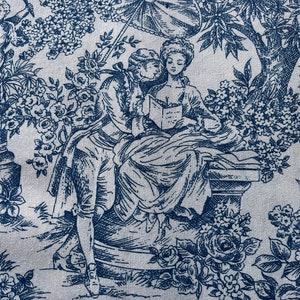 Pode incluir: Um tecido toile azul e branco com um desenho de duas figuras lendo um livro sob uma árvore. O tecido apresenta um padrão repetitivo de flores e folhas.