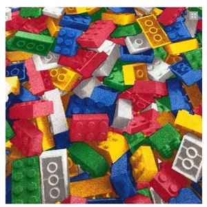 Puede incluir: Una tela colorida con un patrón repetido de bloques de construcción de juguetes en rojo, azul, verde, amarillo y gris.