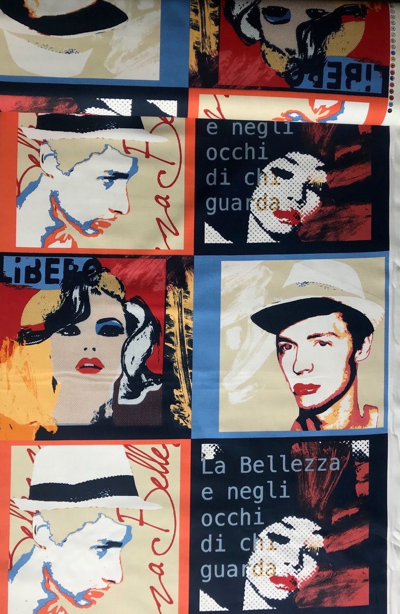 May include: A colorful fabric with a repeating pattern of portraits and text. The portraits are of people wearing hats. The text includes the words "La Bellezza" and "Libera".