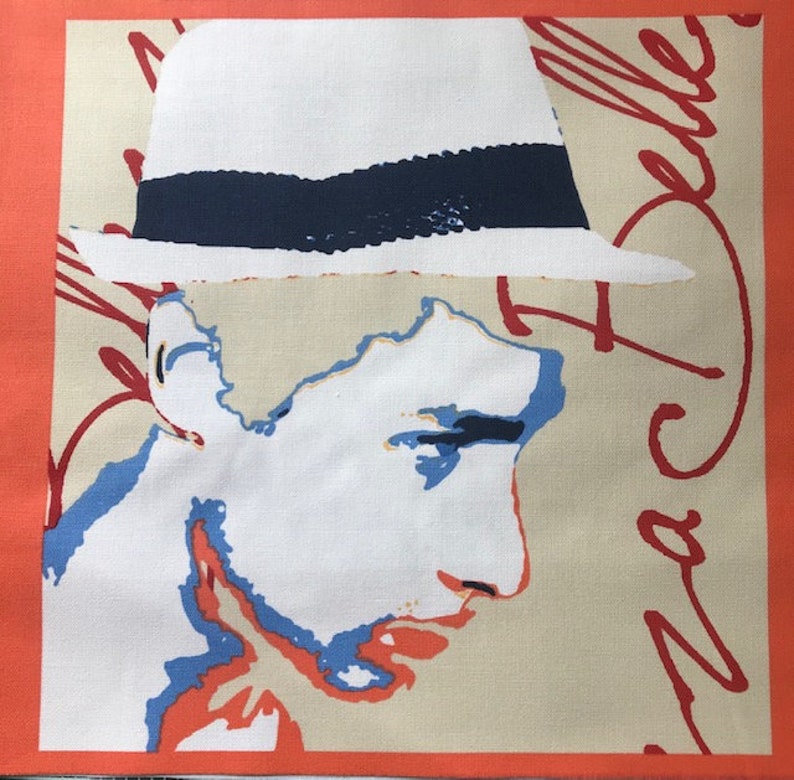 May include: A white hat with a blue band, a red signature, and a colorful portrait of a person with a white background.