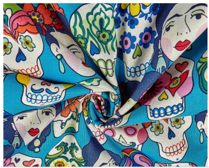 May include: A blue fabric with a repeating pattern of colorful sugar skulls with floral designs. The skulls have black eyes and mouths, and some have mustaches. The fabric is perfect for crafting projects, like making masks, bags, or clothing.