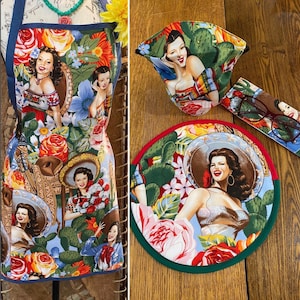 May include: A colorful apron with a floral pattern and images of women. The apron has a blue background with red, yellow, and green flowers. The women are wearing various outfits and have different hairstyles. The apron is perfect for adding a touch of vintage style to any kitchen.