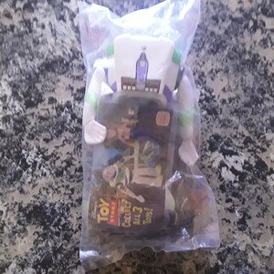 May include: A Buzz Lightyear action figure from the Disney Pixar Toy Story franchise, still sealed in its original plastic packaging. The packaging features the Toy Story logo and the text "Collect All 3 Toys!"