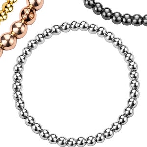 Peut inclure: Quatre bracelets en perles de différentes couleurs : or, or rose, argent et noir. Les bracelets sont faits de petites perles rondes.