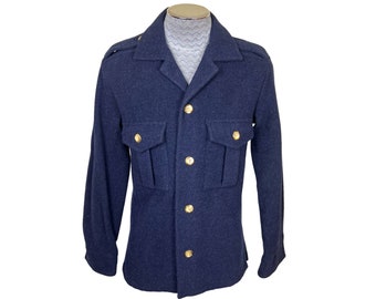 May include: A navy blue wool jacket with gold buttons and flap pockets. The jacket has a collared neckline and long sleeves.