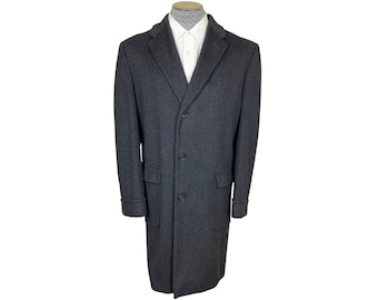 May include: A dark gray wool overcoat with a single-breasted closure and four buttons. The coat has a classic design with a notched lapel and flap pockets.