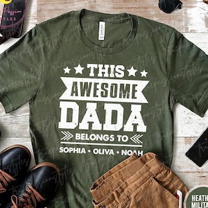 May include: A green t-shirt with white text that reads "This Awesome Dada Belongs To Sophia Olivia Noah".