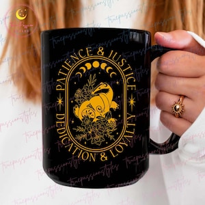 May include: Black ceramic mug with a gold design featuring a badger, flowers, and the text "Patience & Justice, Dedication & Loyalty".