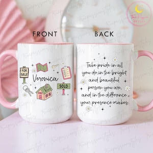 May include: White ceramic mug with a pink handle and rim. The front features real estate-themed illustrations and the name "Veronica." The back has an inspirational quote. A charming and practical gift.