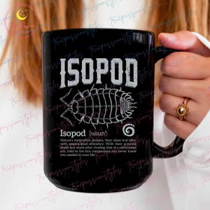 May include: Black coffee mug with a white graphic of an isopod, a small crustacean, and the text "ISOPOD" in large white letters. The text below the isopod reads "Isopod [noun] Nature's meticulous janitors, they clean leaf litter with unparalleled efficiency. With their armored shells and work ethic rivaling that of a caffeinated ant, they're the tiny companions you never knew you needed in your life."