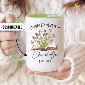 May include: White ceramic mug with a green interior and handle. The mug features the text "CHAPTER SEVENTY" and "Charlotte EST. 1956" with a floral and butterfly design. The word "CUSTOMIZABLE" is also visible.