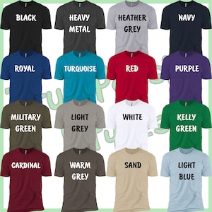 May include: A collage of 16 t-shirts in various colors, each with a different color and text. The colors include black, white, red, blue, green, grey, purple, turquoise, sand, and light blue. The text includes "Black", "Heavy Metal", "Heather Grey", "Navy", "Royal", "Turquoise", "Red", "Purple", "Military Green", "Light Grey", "White", "Kelly Green", "Cardinal", "Warm Grey", "Sand", and "Light Blue".