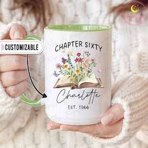 May include: White ceramic mug with a green handle and interior. The mug features the text "CHAPTER SIXTY" and "Charlotte EST. 1966" with a floral and butterfly design. The mug is customizable.