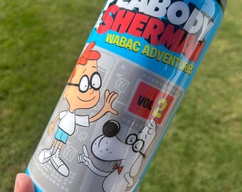 May include: A blue and silver tumbler featuring the cartoon characters Mr. Peabody and Sherman. The tumbler has the words "Mr. Peabody & Sherman" and "WABAC Adventures" printed on it. The tumbler has a black lid and a clear straw.