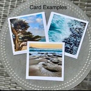 May include: Three square greeting cards with scenic images of nature, including a tree, ocean waves, and a beach scene. The cards are displayed on a gray, textured surface. The text "Card Examples" is visible at the top.