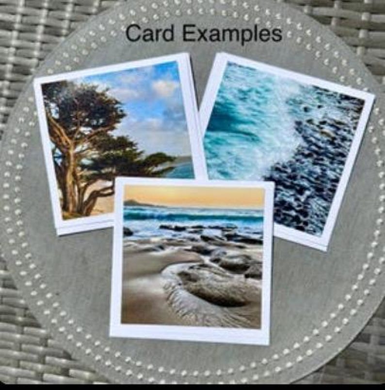 May include: Three square greeting cards with scenic images of nature, including a tree, ocean waves, and a beach scene. The cards are displayed on a gray, textured surface. The text "Card Examples" is visible at the top.
