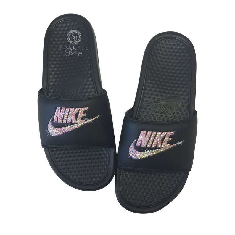 black nike slides with gold swoosh