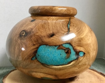 This is a Mesquite bowl with Turquoise Inlay, it is 7” tall by 9” wide